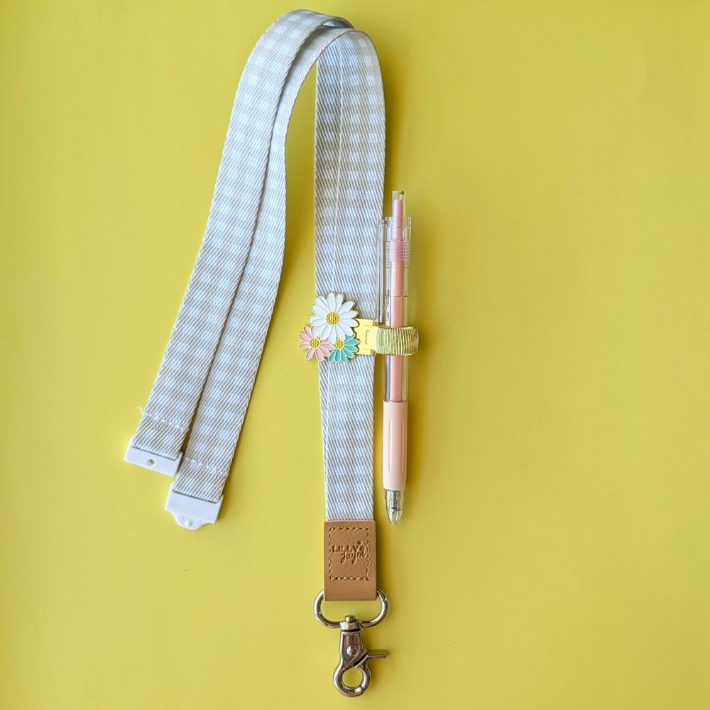 Lanyard with a pen holder and pen on a yellow background