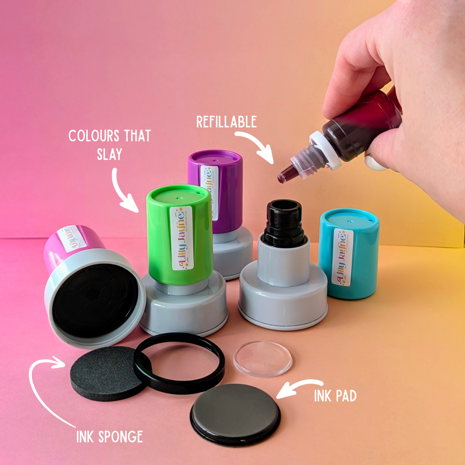 Ink refill kit with ink pads and a hand pouring ink, on a gradient pink and yellow background.