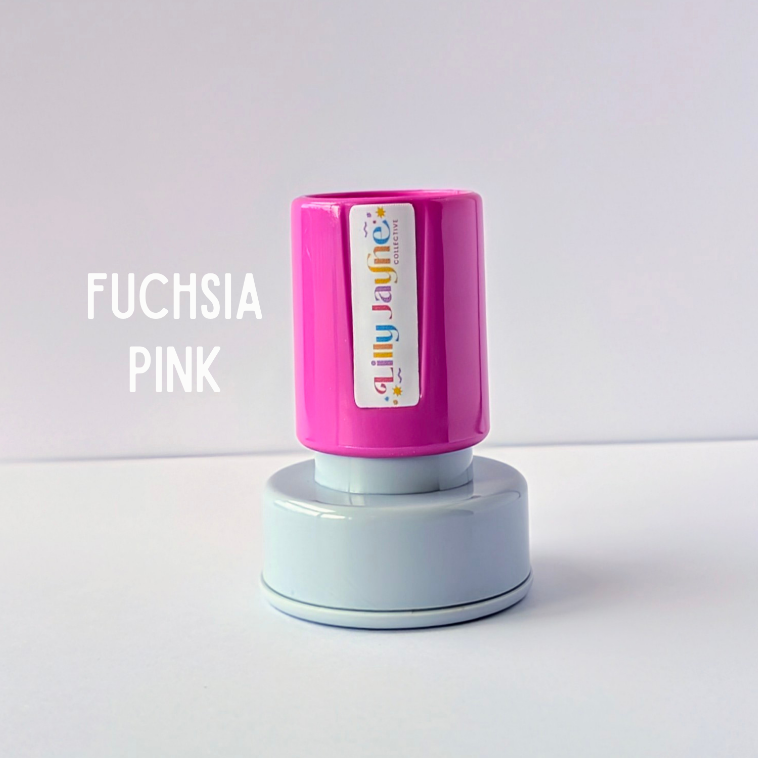 Pink stamp with 'Lilly Jayne Collective' branding on a light grey background