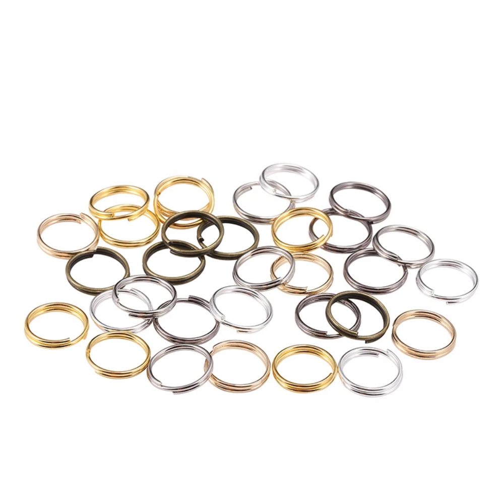 Assorted gold, silver, and black jump rings on a white background