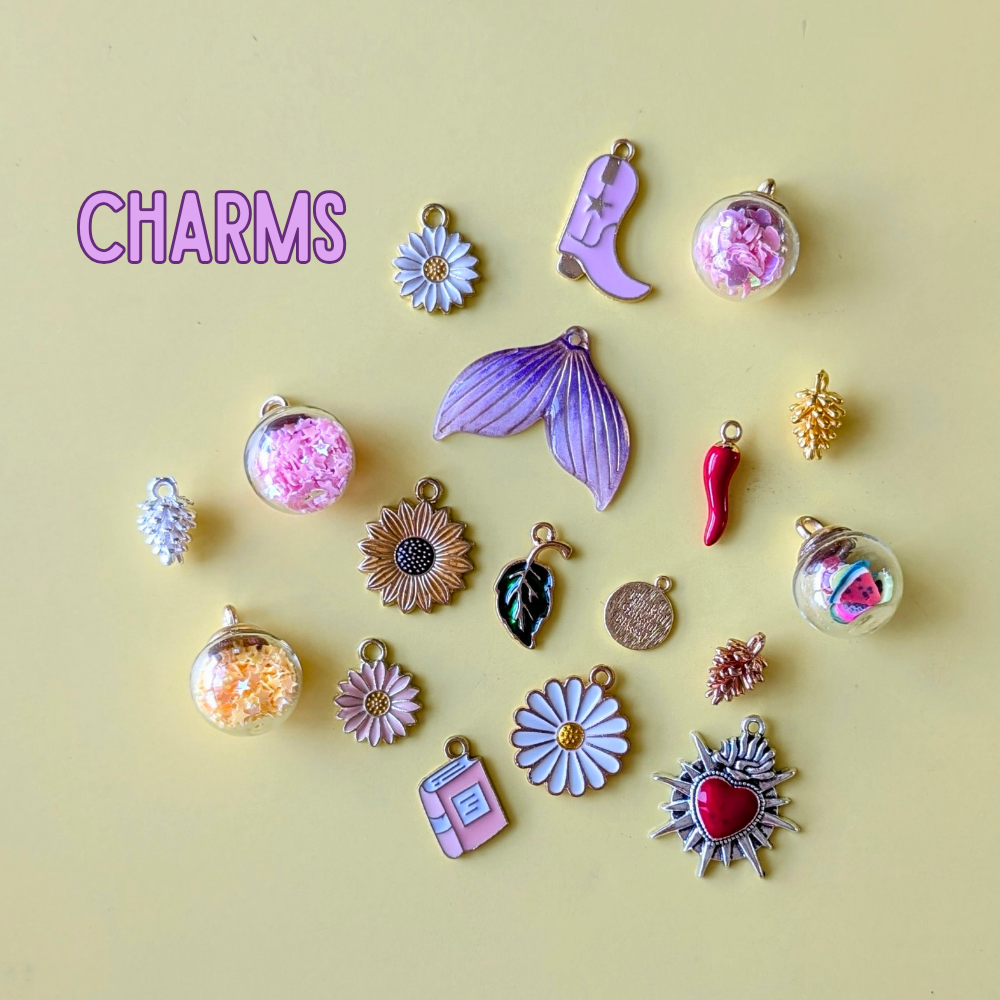 Collection of various charms on a yellow background with 'CHARMS' text.
