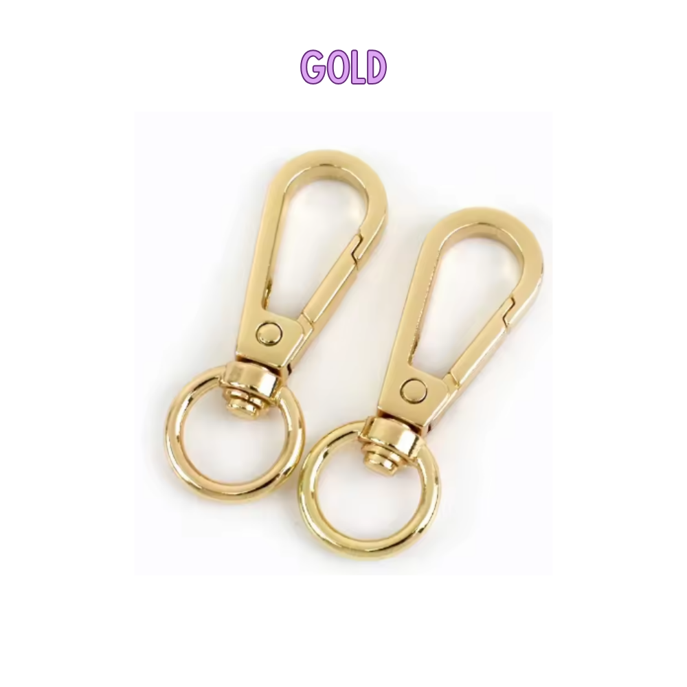 Two gold keychains with a clear background