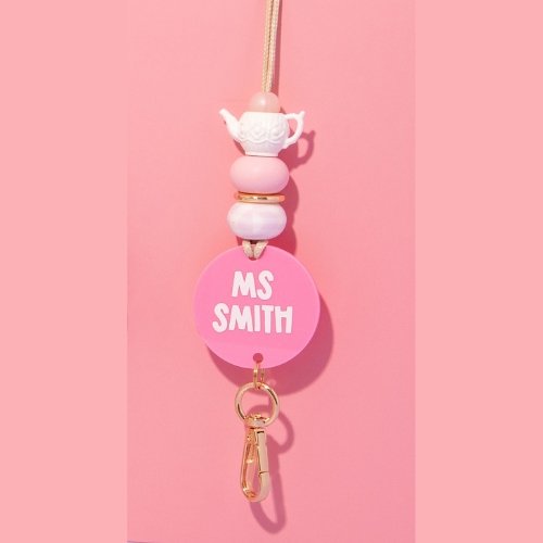 Pink badge holder with 'MS SMITH' text on a pink background