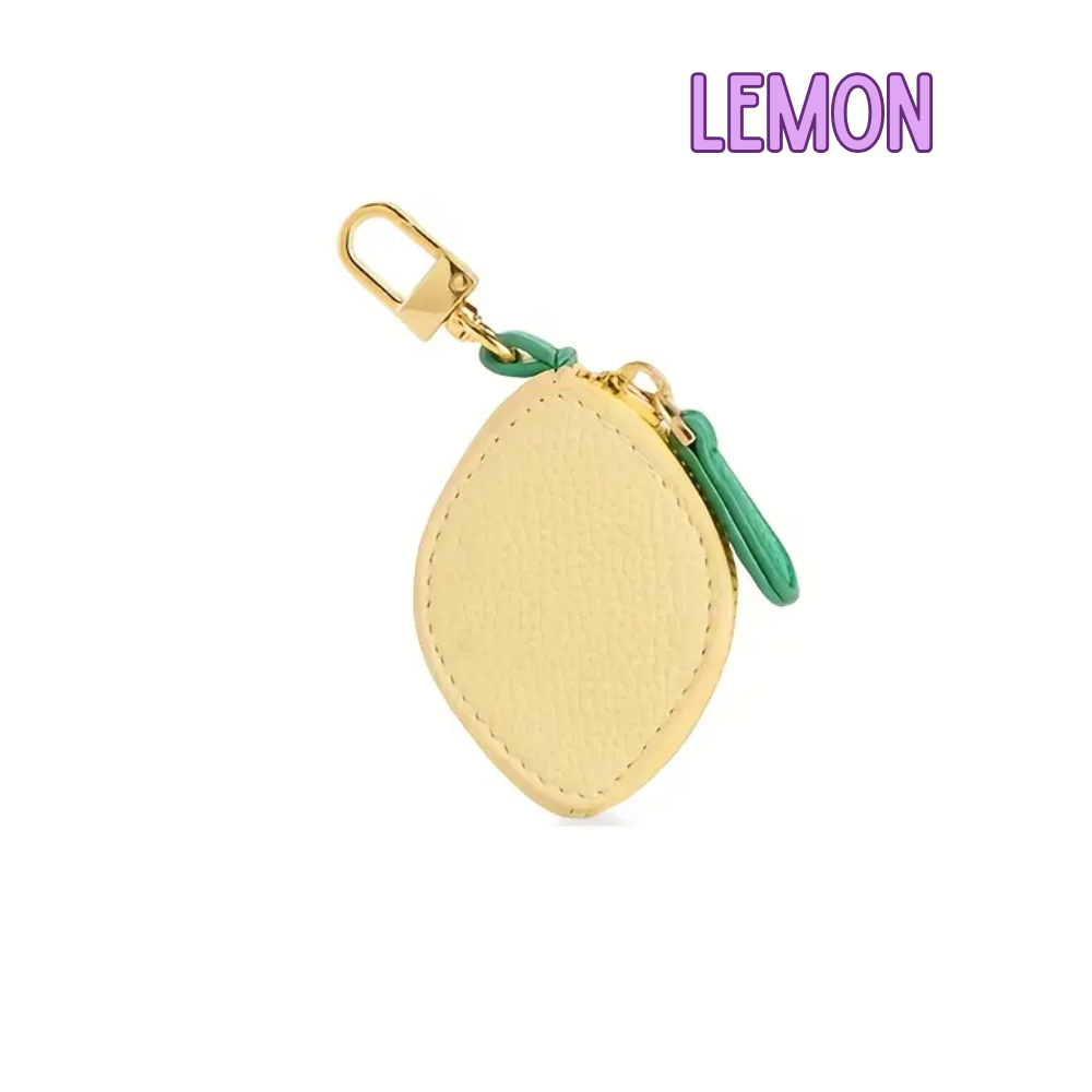 Yellow lemon-shaped keychain with a gold clasp on a white background