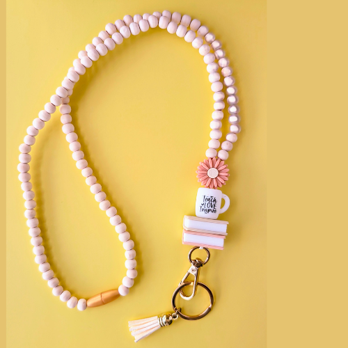 Beaded keychain with decorative elements on a yellow background
