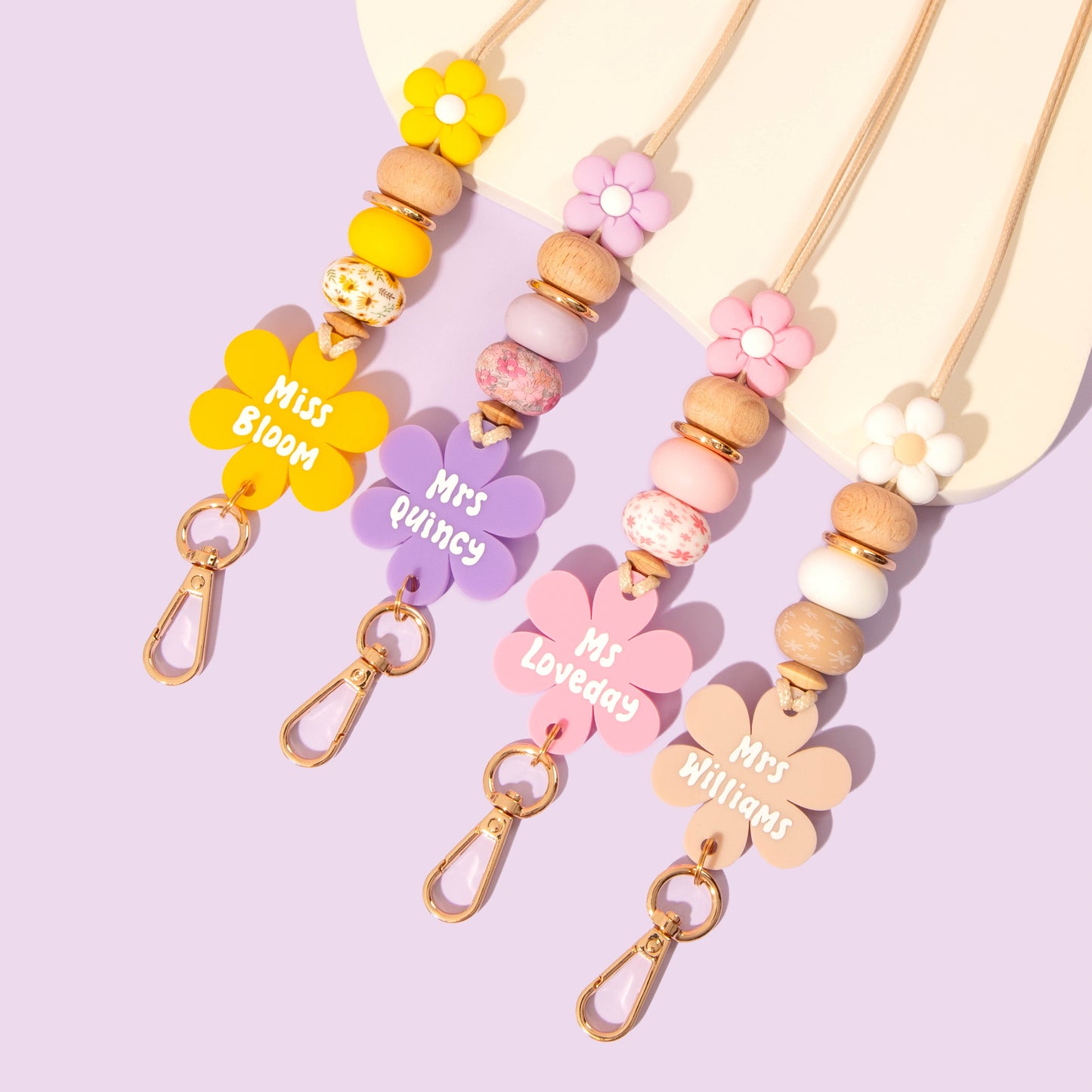 Collection of all 4 Flower personalised lanyards from the Blooms and Beads Collection. Yellow, Pink, purple and Beige options.