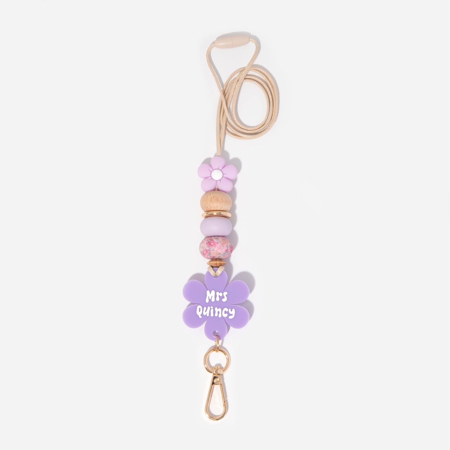 Lanyard with purple flower silicone focal beads and a matching purple flower personalised name disc. With wooden Bead and pretty floral and purple silicone beads.