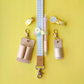 Leather keychains, lanyard, and pen on a yellow background