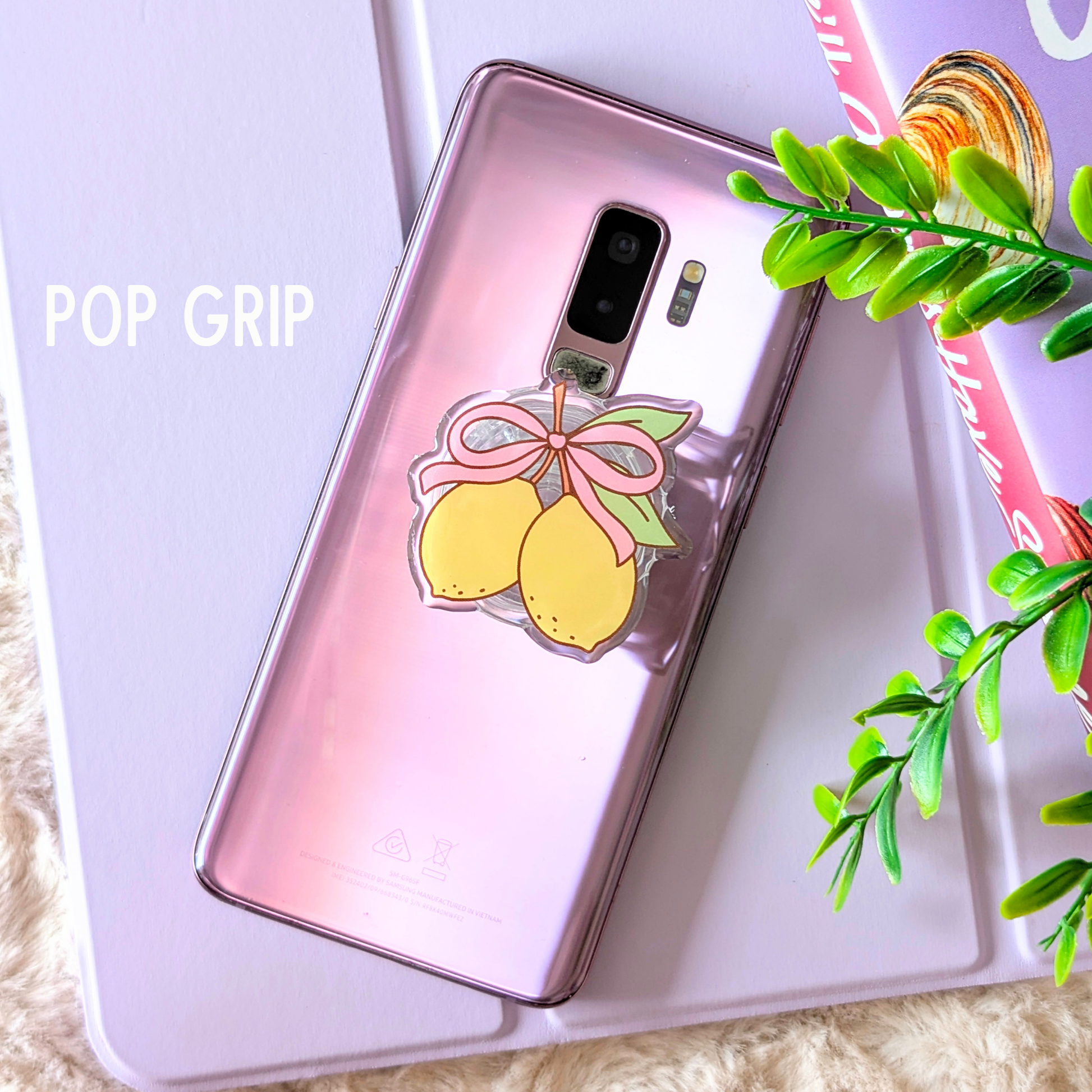 Phone case with lemon design and 'POP GRIP' text on a light background