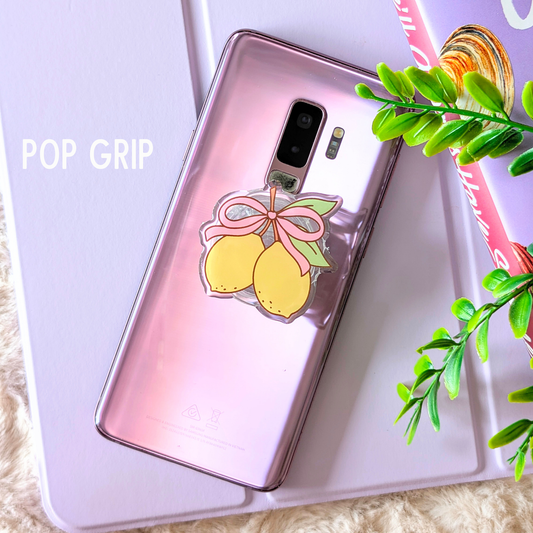 Phone case with lemon design and 'POP GRIP' text on a light background
