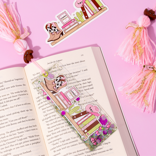Decorative bookmarks with cartoon characters on an open book against a pink background