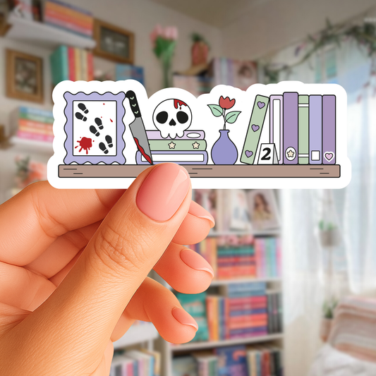 Hand holding a sticker with various illustrations in front of a blurred bookshelf background