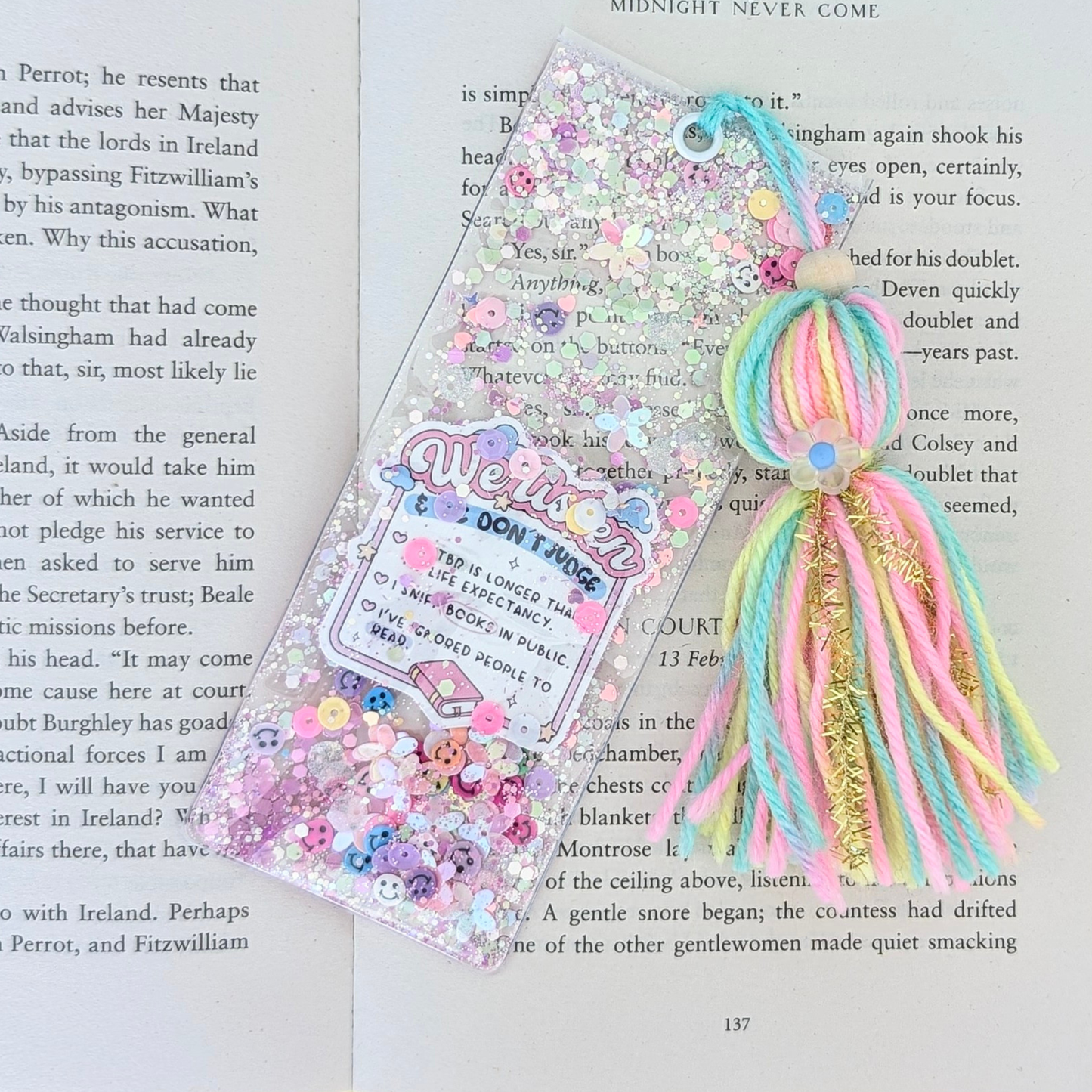 Colorful decorative bookmark with tassels on a book page