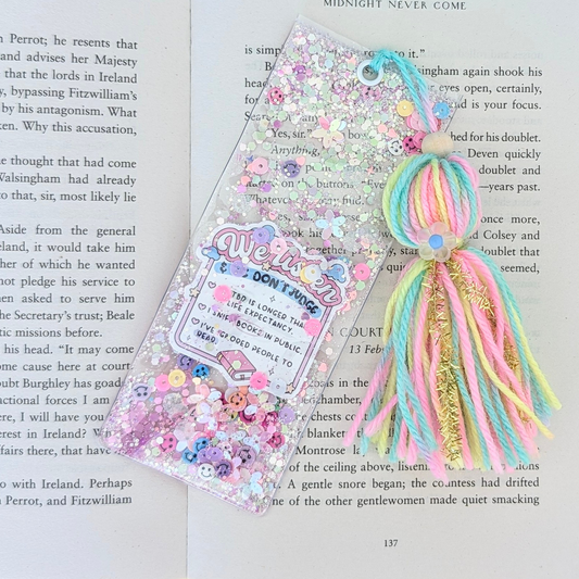 Colorful decorative bookmark with tassels on a book page