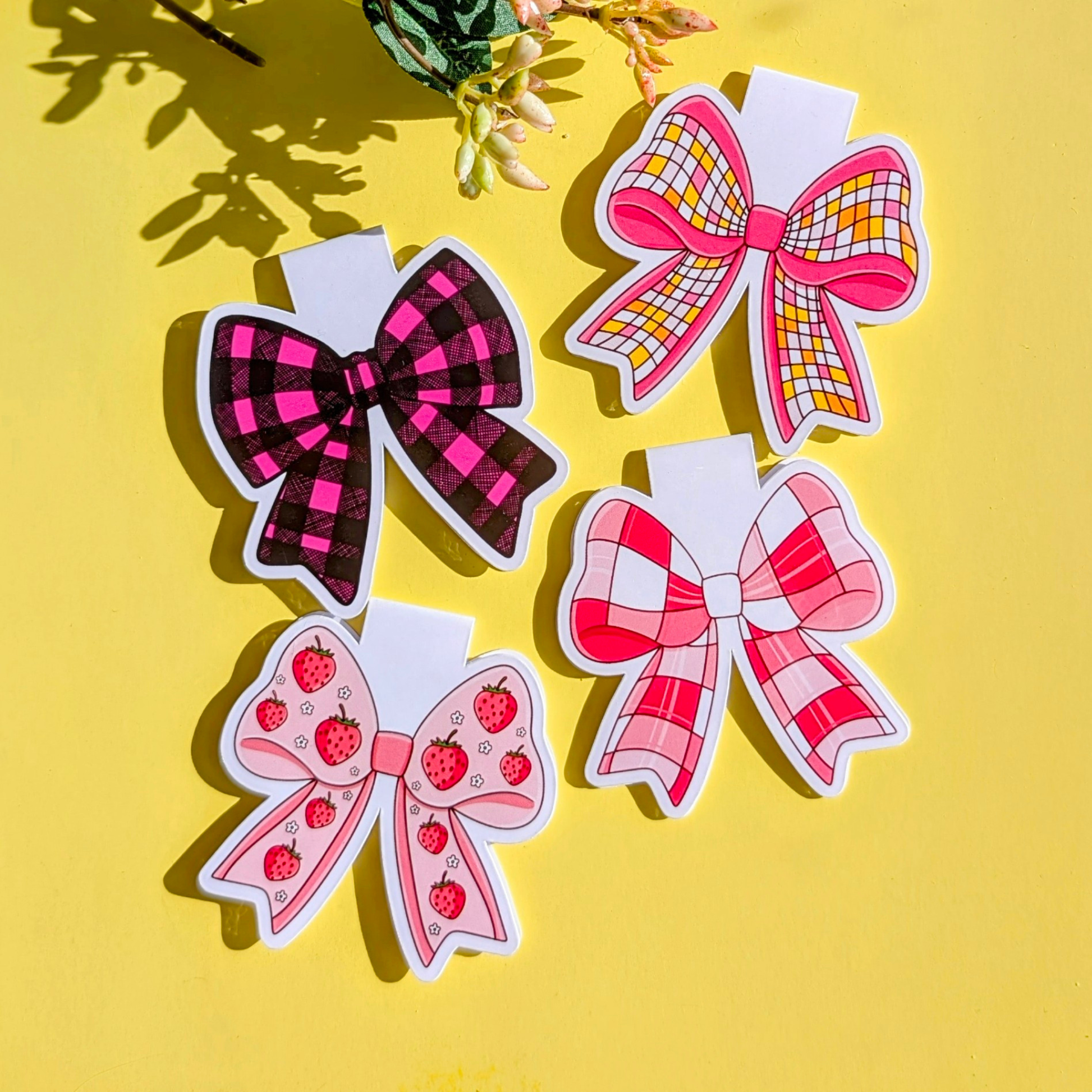 Four decorative bows with different patterns on a yellow background