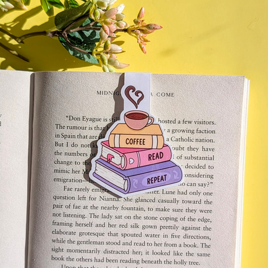 Colorful book-shaped bookmark on an open book with a yellow background and flowers.