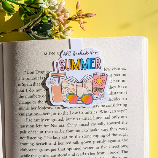Book with a 'Summer' themed bookmark on a yellow background