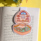 Decorative pop-up bookmark on an open book with a yellow background