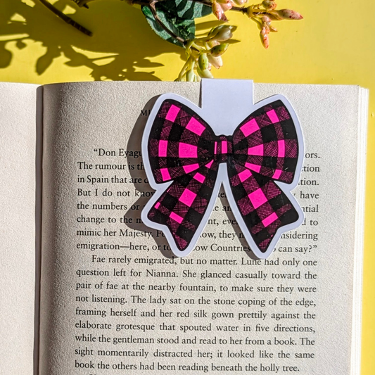 Plaid bow sticker on an open book with a yellow background