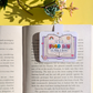 Book with a bookmark that says 'It is a good day to read a book' on a yellow background