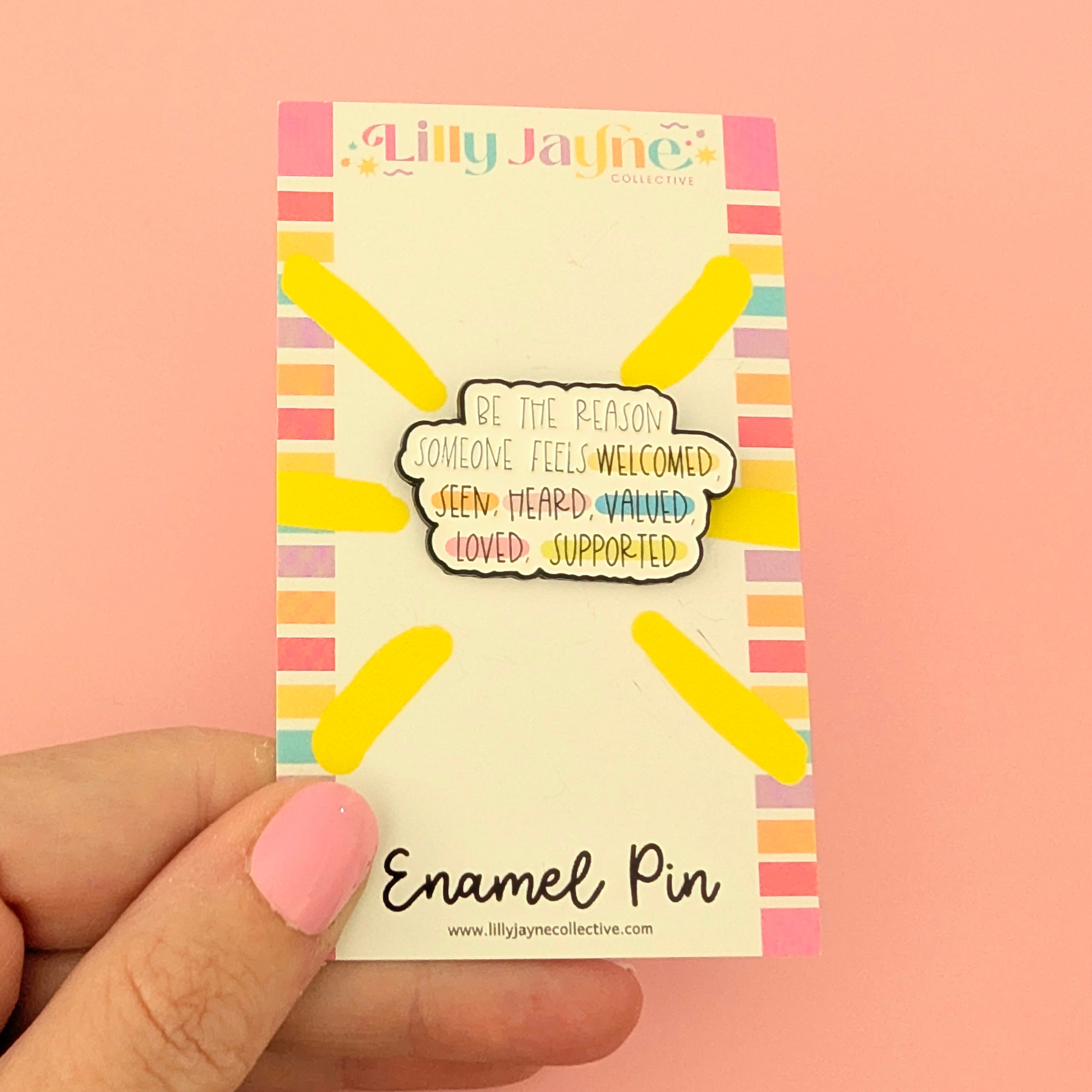 Enamel pin packaging with colorful design and text on a pink background