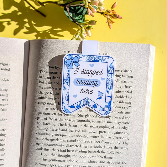Book with a bookmark that says 'I stopped reading here' on a yellow background