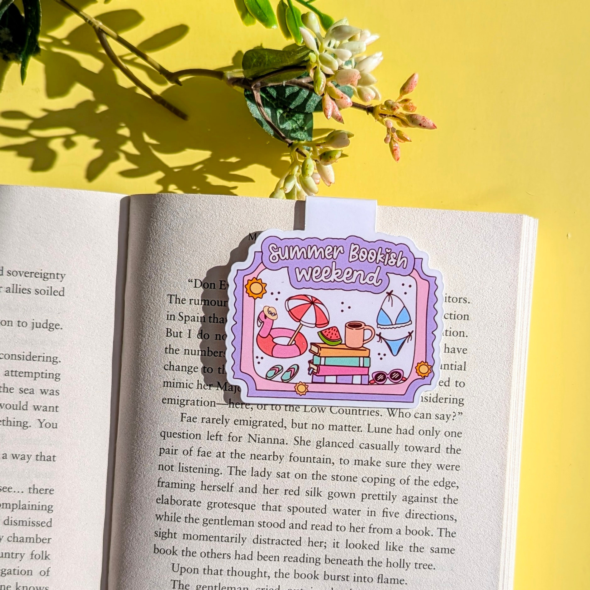 Open book with a 'Summer Bookish Weekend' sticker on a yellow background