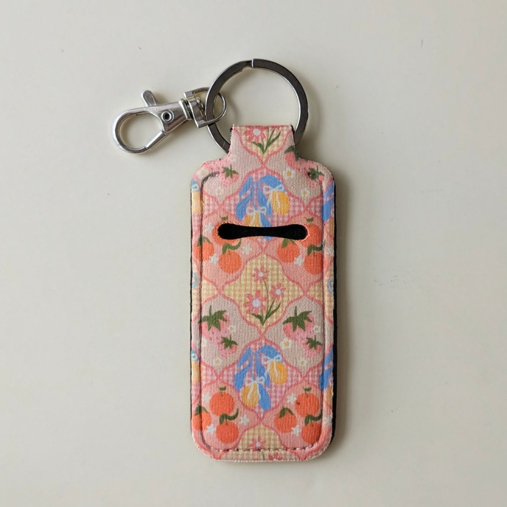 Floral patterned keychain pouch on a light gray background