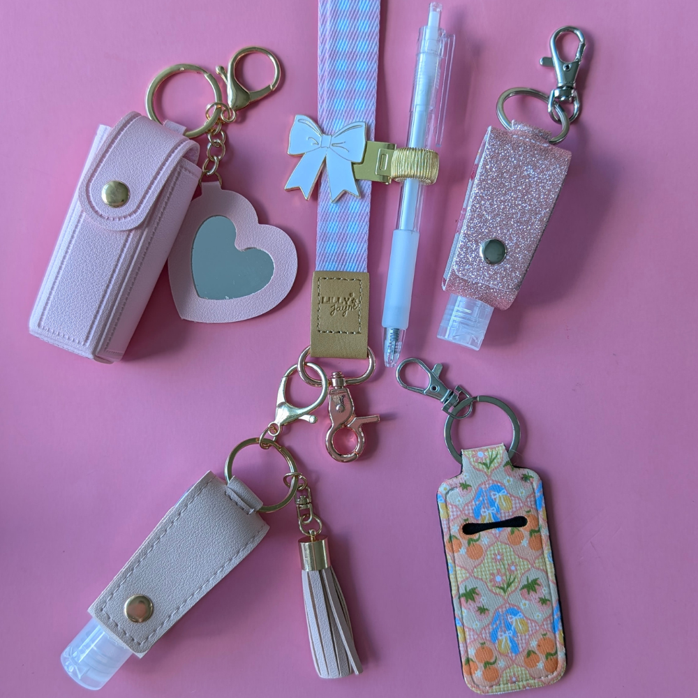 Collection of keychains and pouches on a pink background