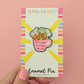 Enamel pin on a colorful backing card held against a pink background