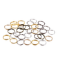 Assorted gold, silver, and black jump rings on a white background
