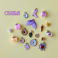 Collection of various charms on a yellow background with 'CHARMS' text.