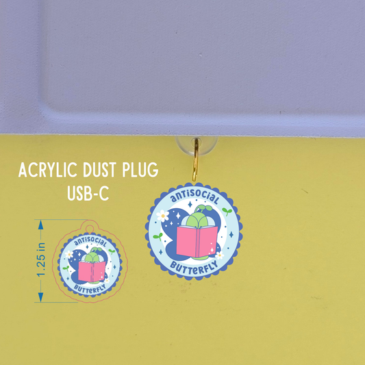 Acrylic dust plug with 'antisocial butterfly' design on a yellow background