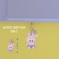 Acrylic dust plug with a cute character design on a green background