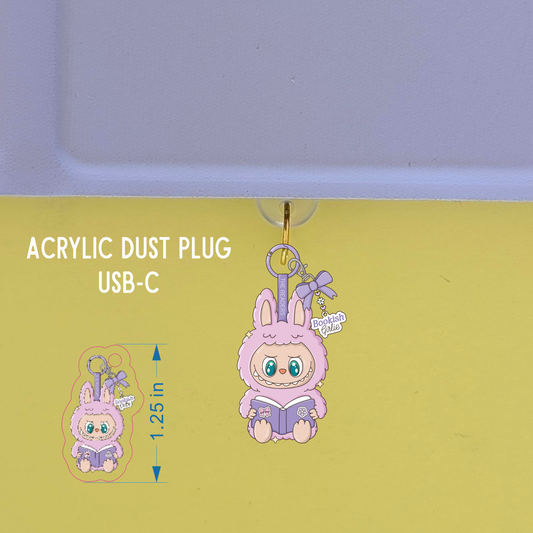 Acrylic dust plug with a cute character design on a green background