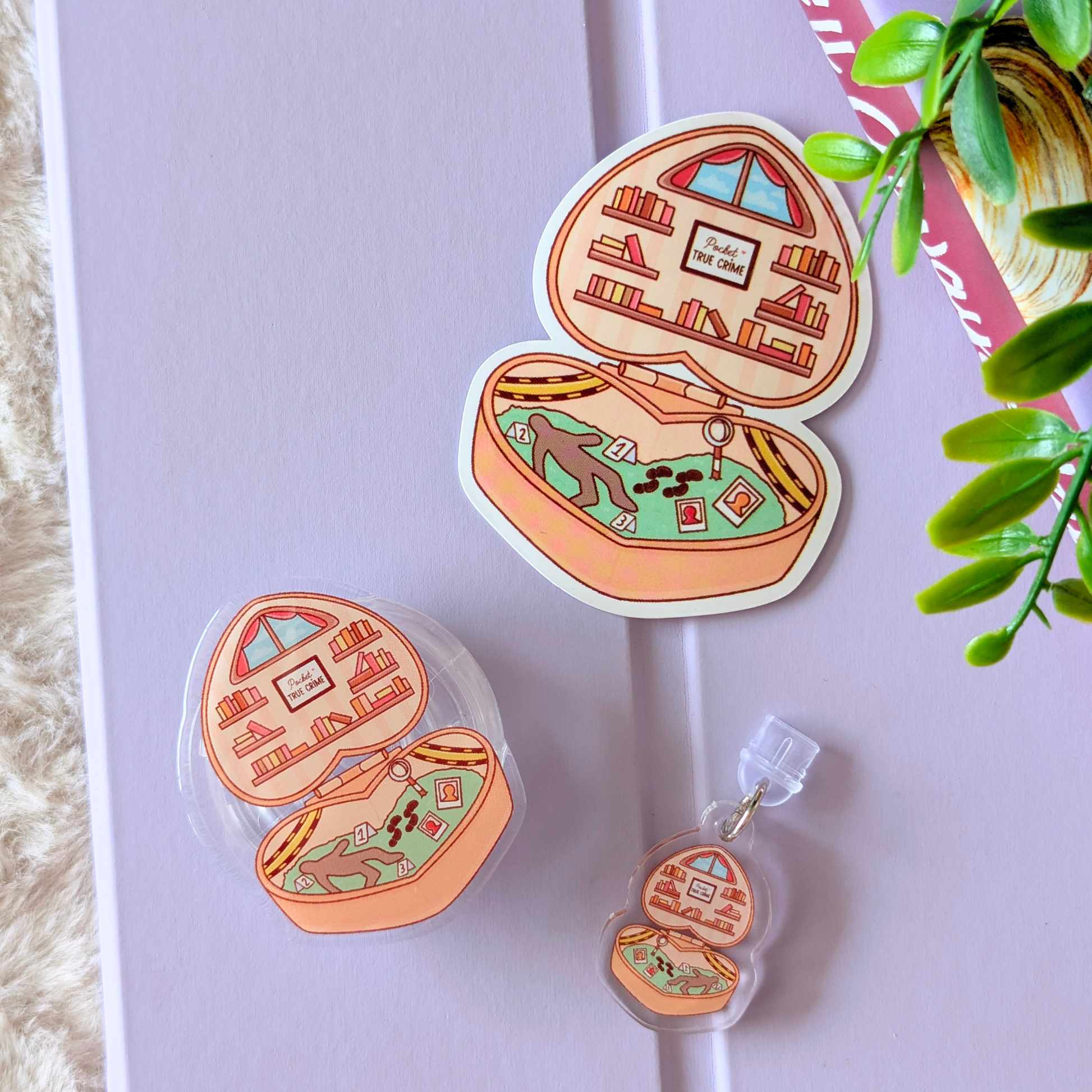 Illustrated earbud cases with scenes inside on a light purple surface.