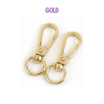 Two gold keychains with a clear background
