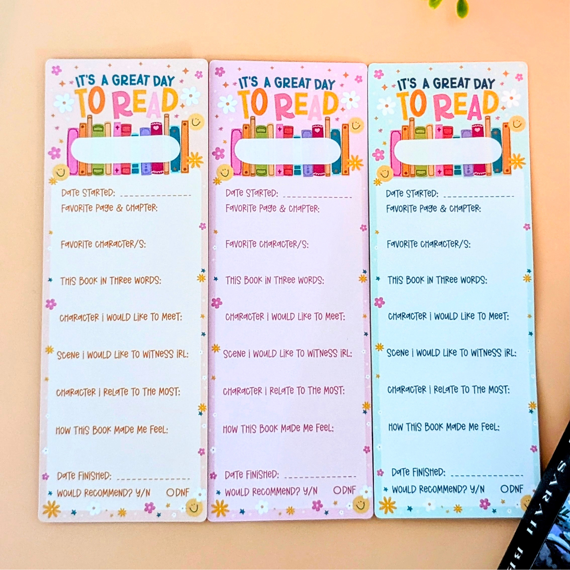 Three colorful reading logs on a wooden surface