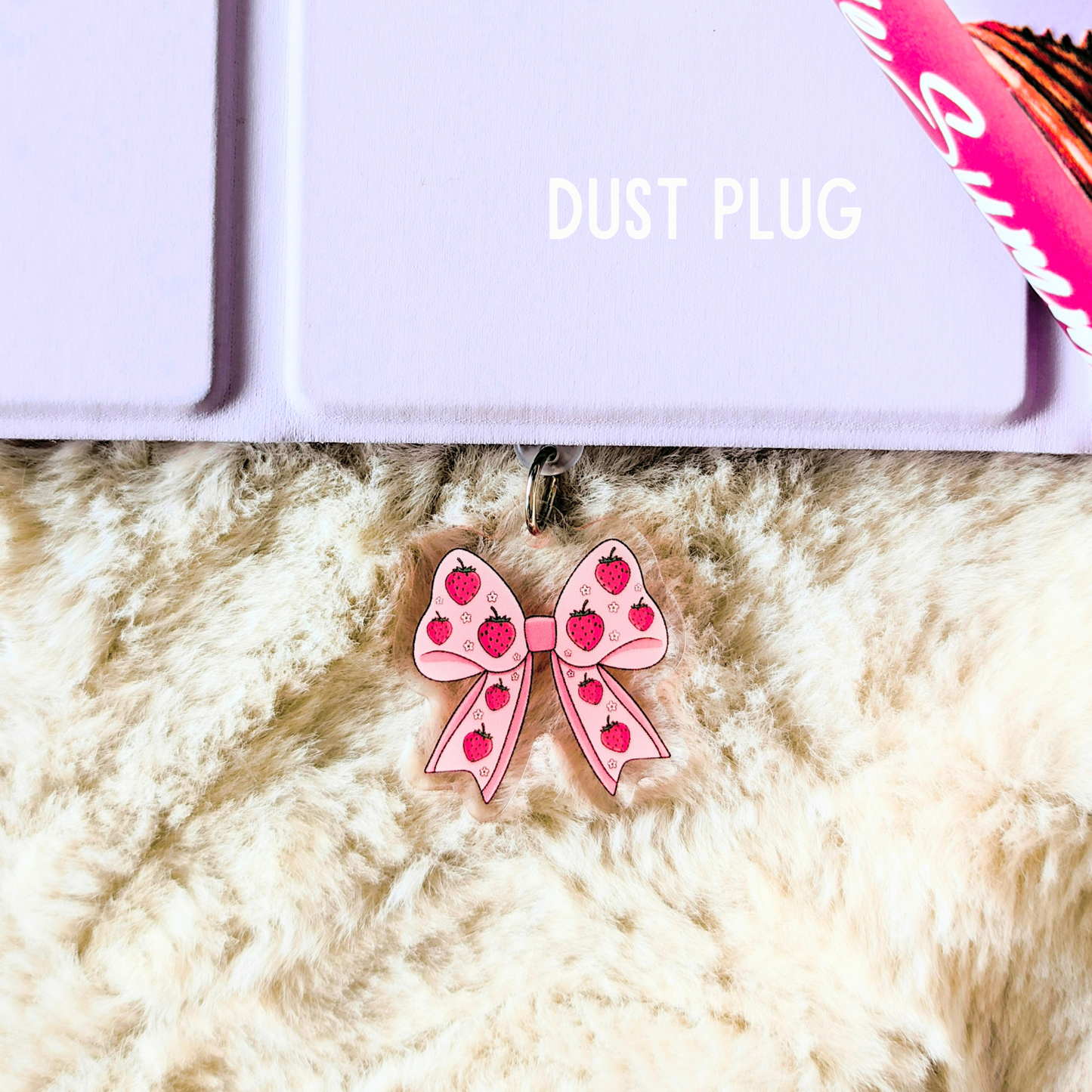 Pink bow with red hearts on a fluffy white surface, with 'DUST PLUG' text above.