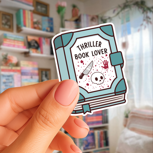 Sticker of a book titled 'Thriller Book Lover' held by a hand with a blurred bookshelf background.