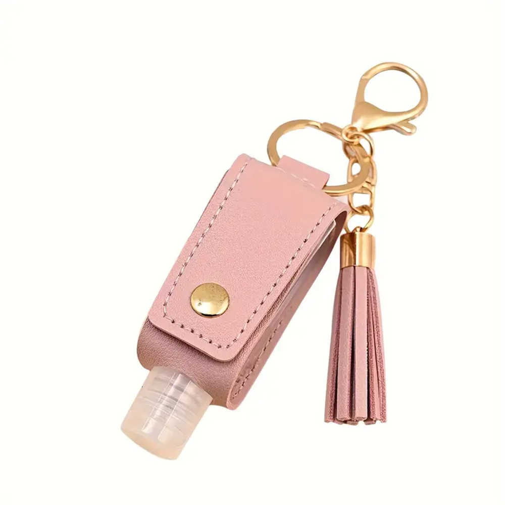 Pink hand sanitizer holder with tassel keychain on a white background