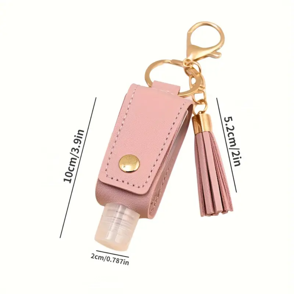 Pink keychain with tassel and hand sanitizer bottle, showing measurements on a white background