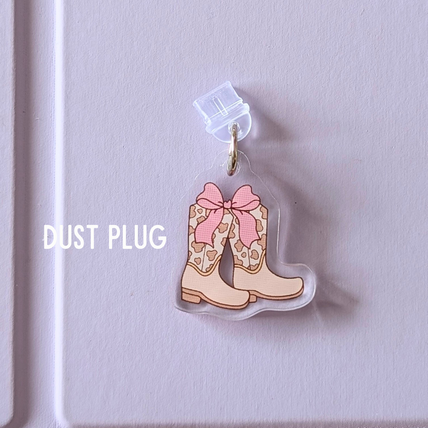 Dust plug with cowboy boot design on a light purple background