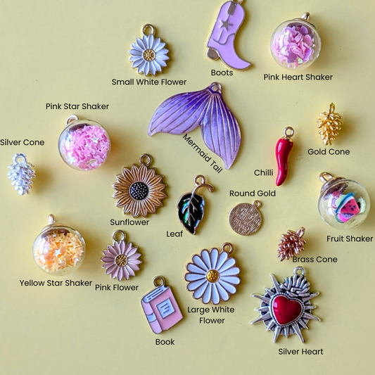 Collection of various charms on a beige background with labels.