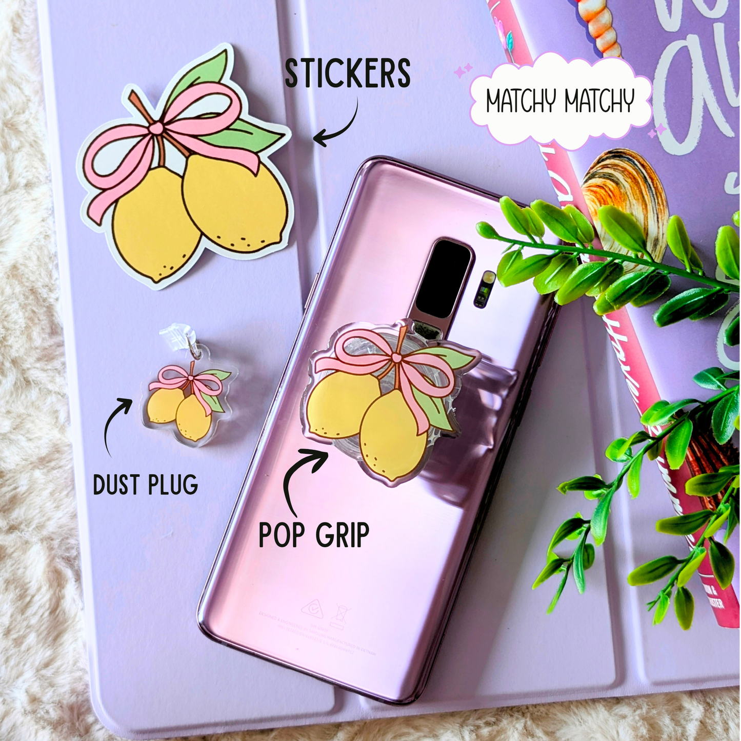 Phone case with lemon design, pop grip, dust plug, and stickers on a purple background.