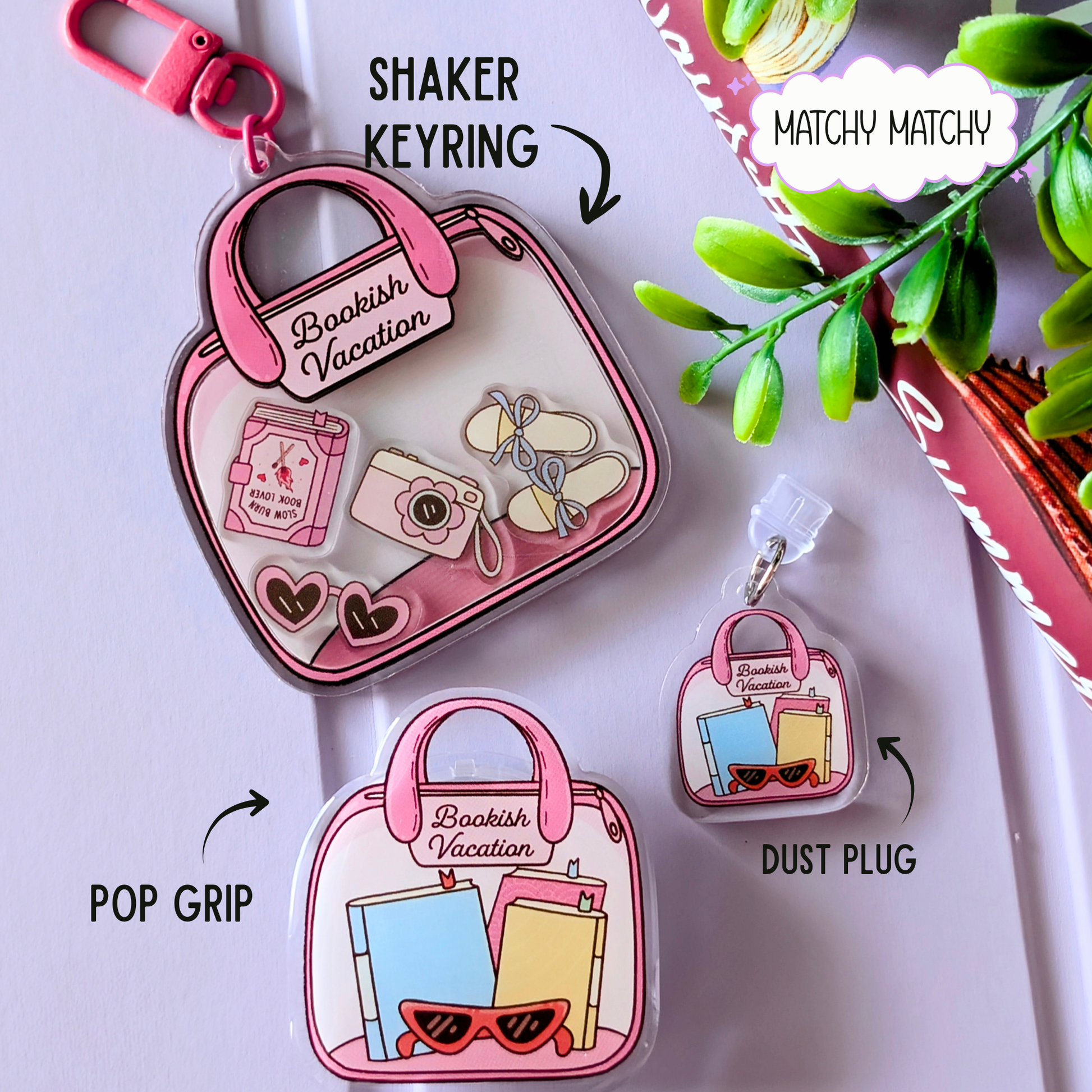 Pink shaker keyring with 'Bookish Vacation' design, pop grip, and matchy matchy elements on a white background.