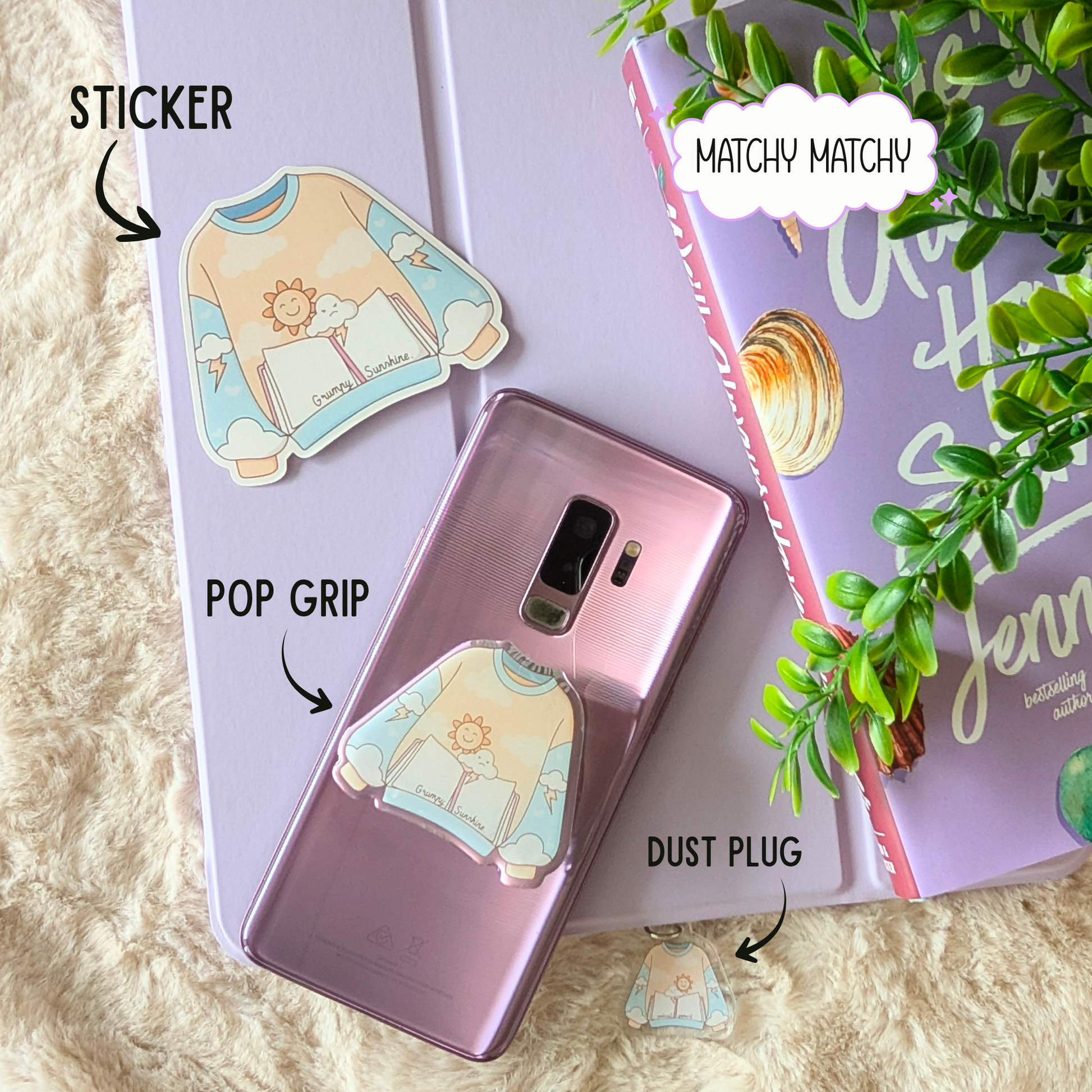 Phone case with pop grip, sticker, and dust plug on a book with plant