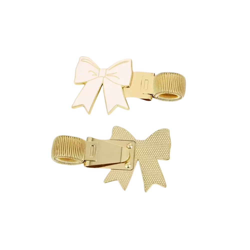 Two gold hair clips with bow designs on a white background