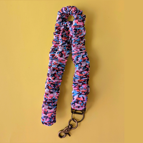 Multicolored scrunchie with a keychain on a yellow background