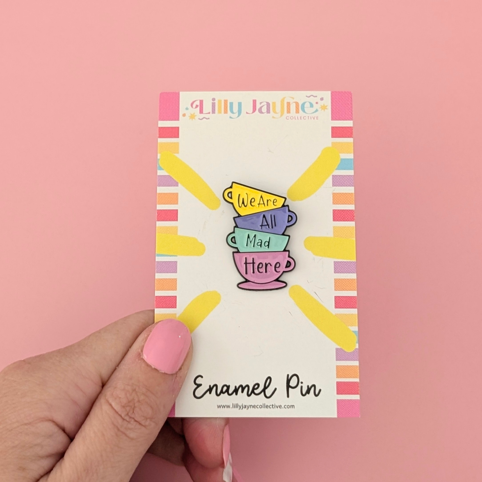 Lilly Jayne enamel pin packaging with colorful design on a pink background
